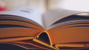 Detailed close-up of an open book with yellow pages, emphasizing learning and knowledge.